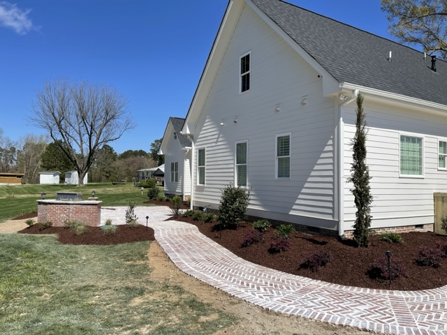 Brick Walkway with Landscaped Garden