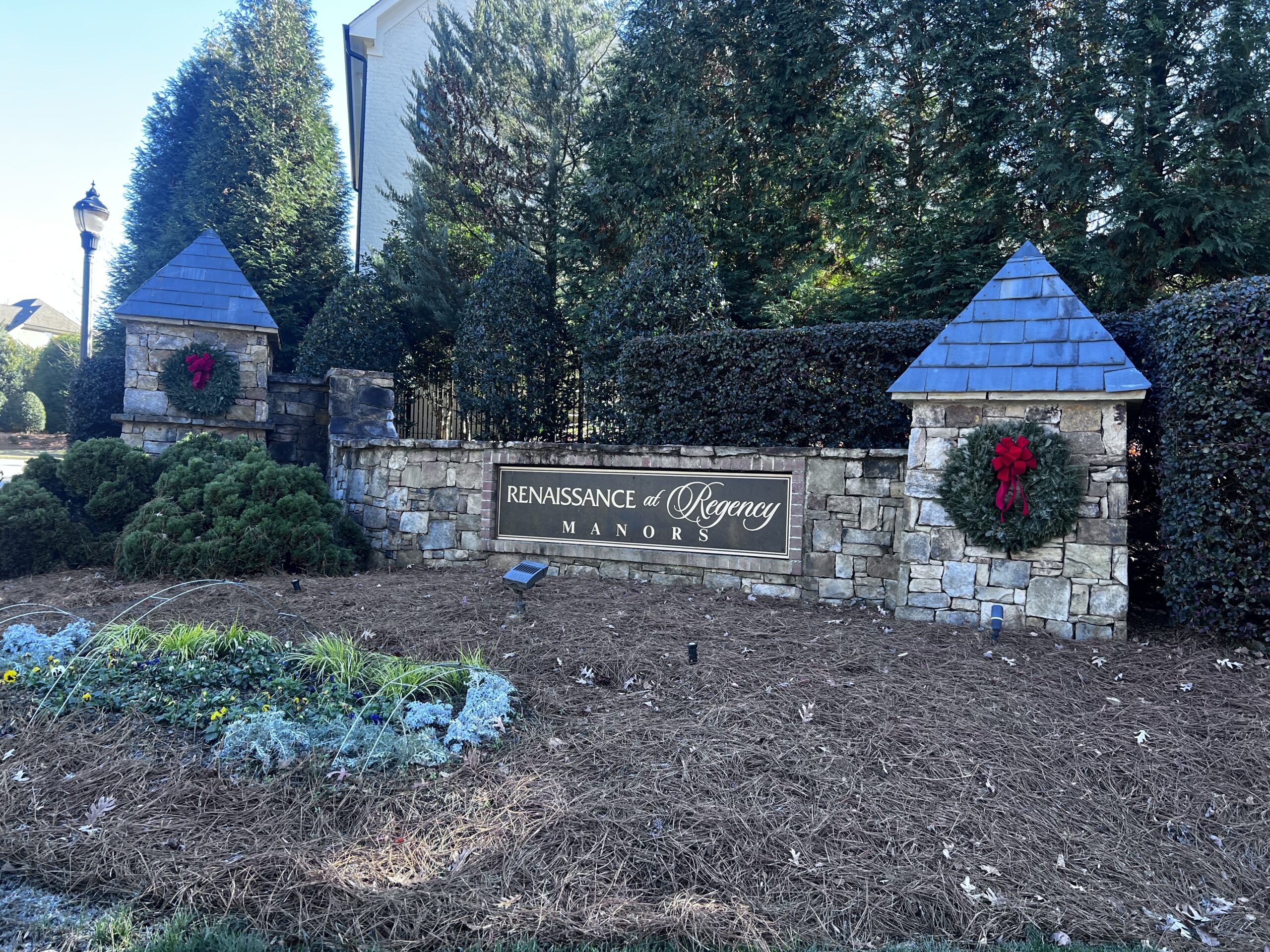 Luxury community entrance with landscaping.